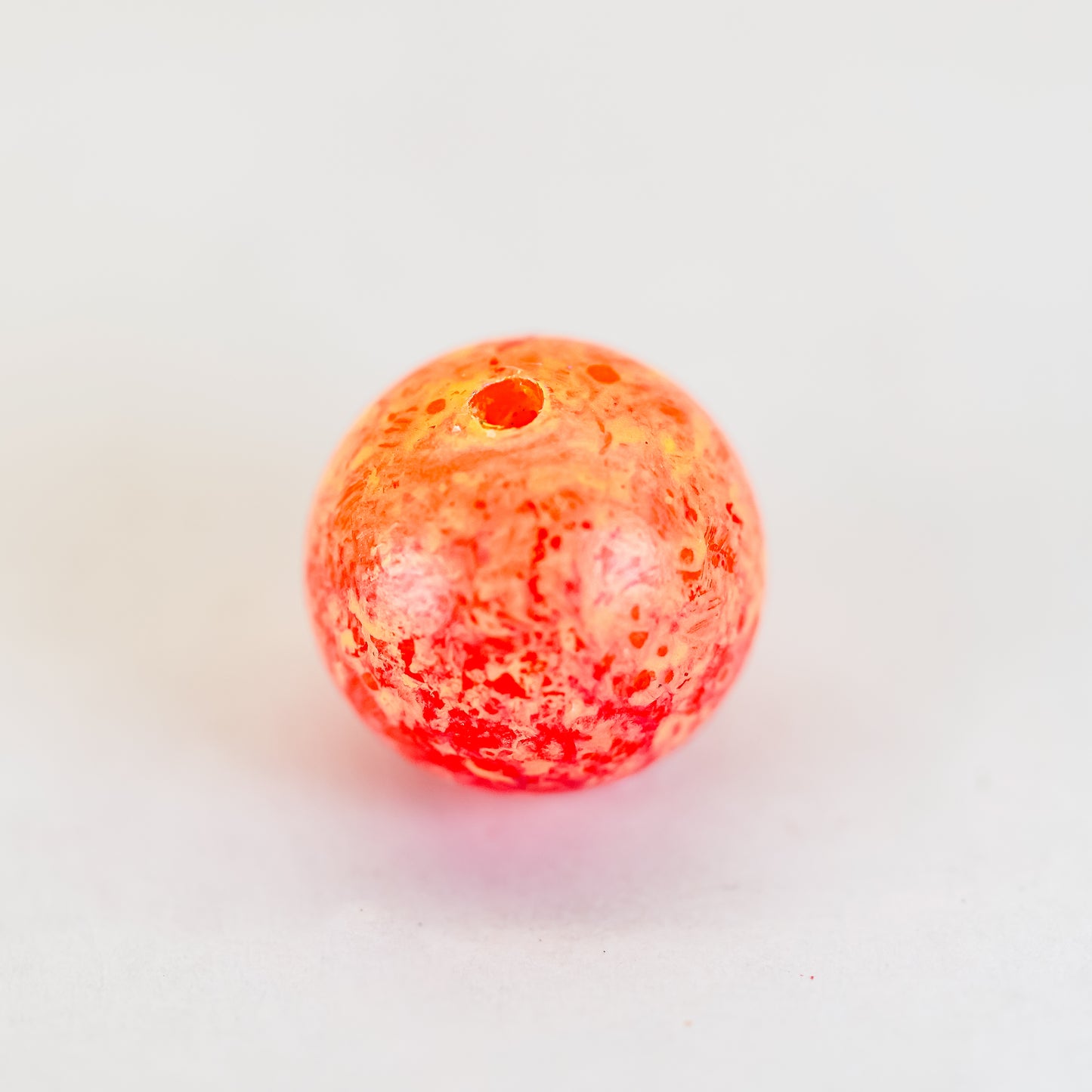 Close-up of a cluster of durable plastic beads designed to imitate salmon eggs, used as fishing bait, arranged to resemble a natural egg cluster for effective presentation.