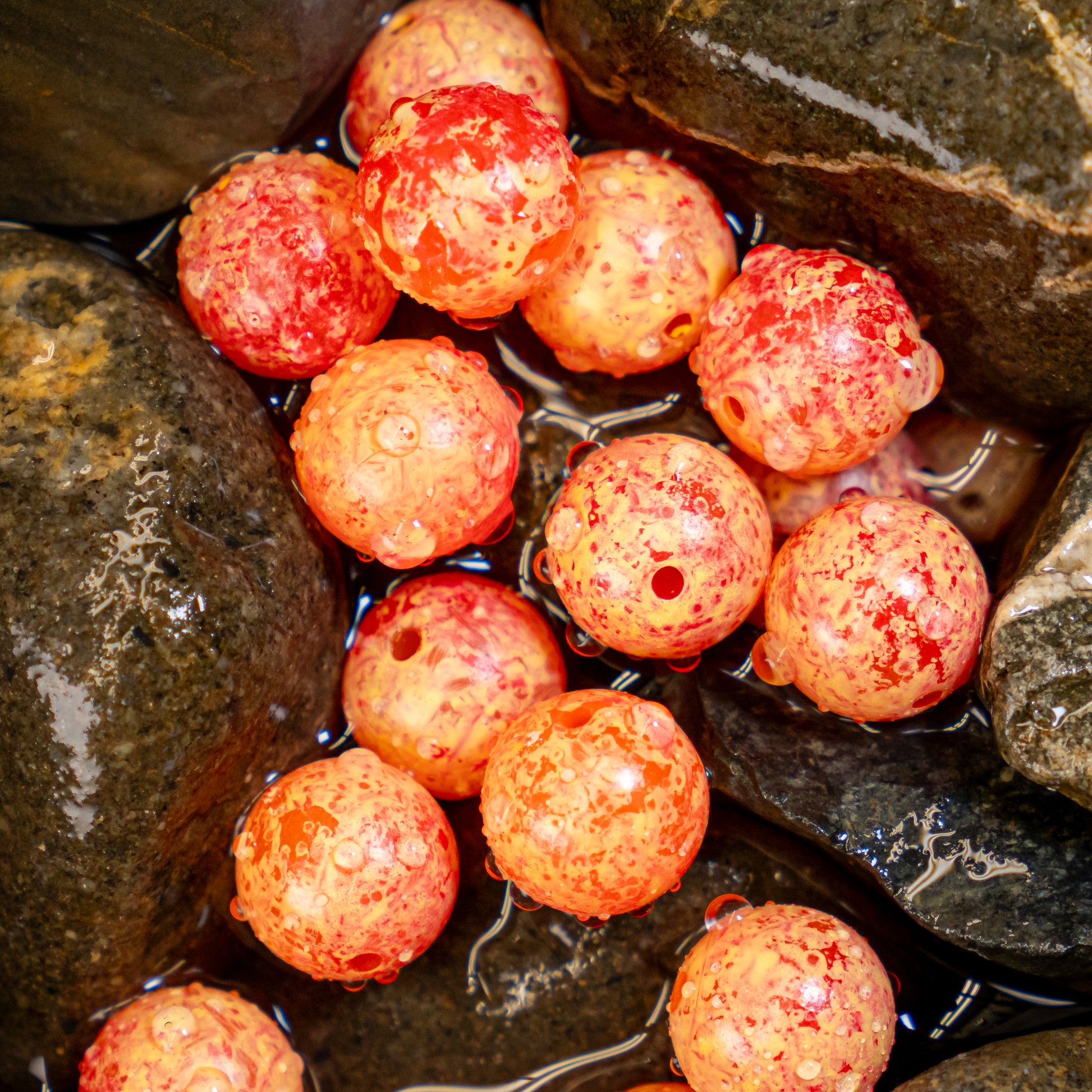 Close-up of a cluster of durable plastic beads designed to imitate salmon eggs, used as fishing bait, arranged to resemble a natural egg cluster for effective presentation.